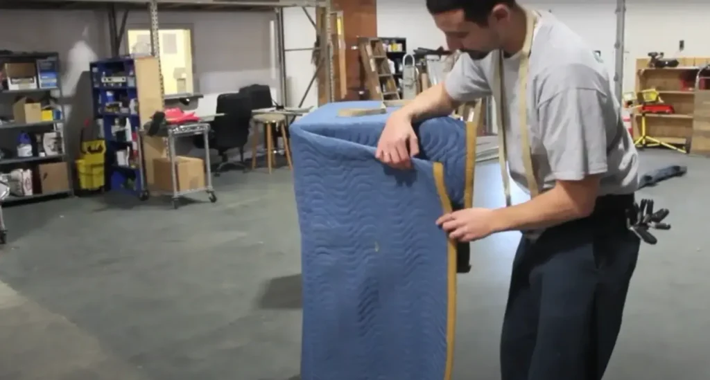 Mover folding a moving pad in the garage